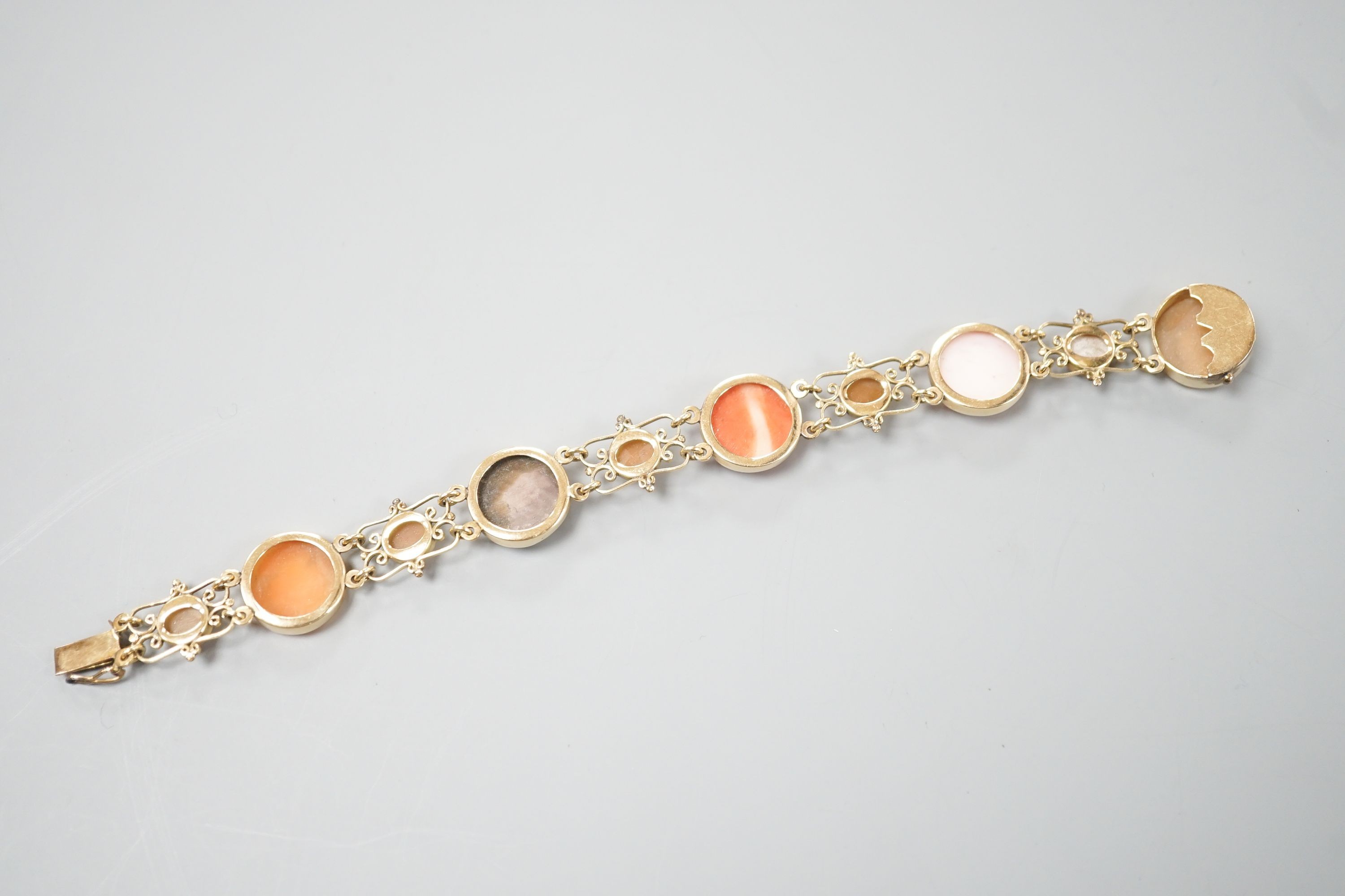 A 14k yellow metal gold Neapolitan shell and coral cameo set bracelet, 16.3cm, gross weight 13.4 grams.